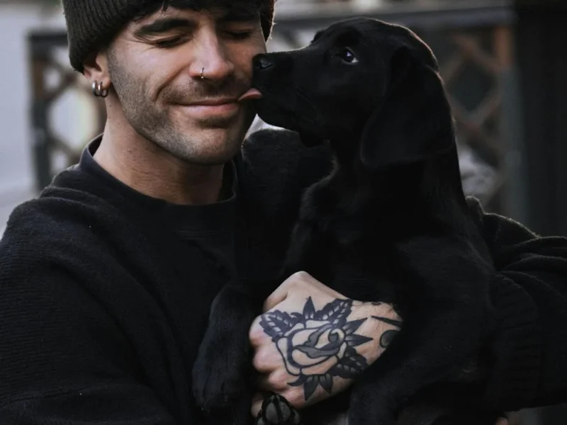 A man holding a small dog